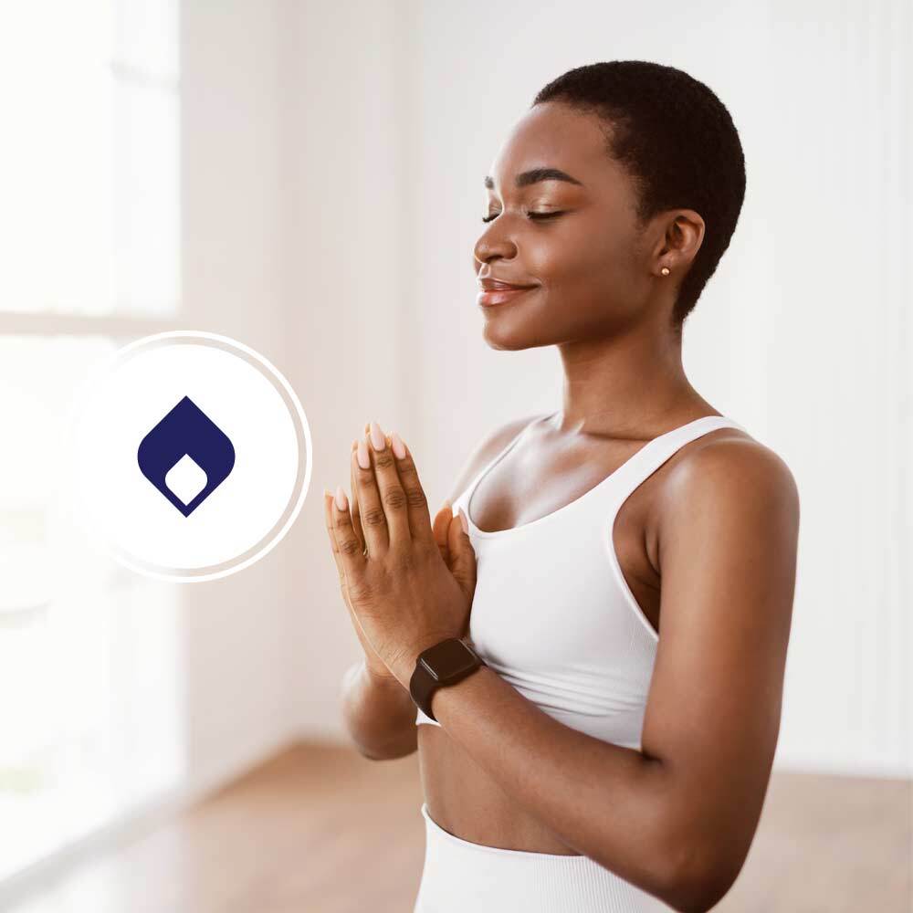 Woman standing holding hands together in yoga pose